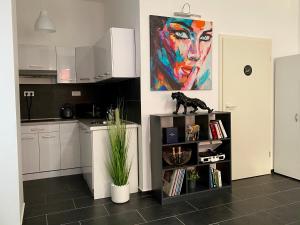 a kitchen with a dog statue on top of a book shelf at GelsenDesign - Gemütliches Studio-Apartment in Gelsenkirchen