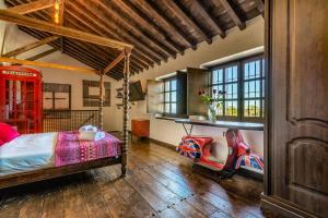 a bedroom with a bed and a desk and chairs at Cortijo Boutique Marbella in Marbella +37 photos
