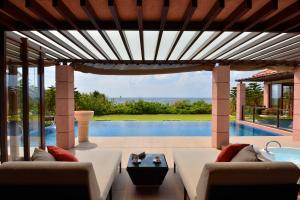 a patio with a view of a swimming pool at The Shigira in Miyako-jima