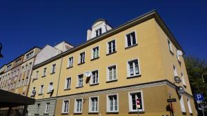 a yellow building with a clock tower on top of it at Apartament w samym sercu Opola 2 in Opole