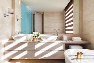 a bathroom with two sinks and a mirror at Sani Dunes in Sani Beach
