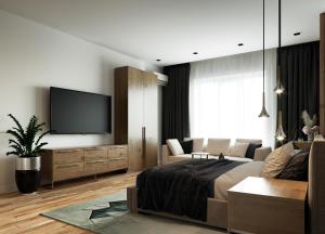 a living room with a bed and a flat screen tv at Privilege Suites by Central Park in Belgrade