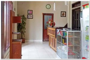 a hallway with a room with a cabinet and a door at Mahkota Intan Syariah Balikpapan RedPartner in Balikpapan