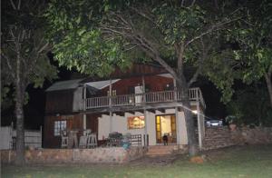 a large house with a deck on the side of it at Hippo Retreat & Tiger Fishing Komatipoort in Komatipoort