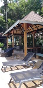 a pavilion with a lounge chair and a picnic table at Cocoville Phuket - SHA Plus in Chalong 