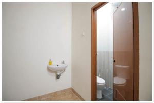 a bathroom with a toilet and a sink at RedDoorz Syariah @ Jatinegara in Jakarta