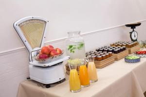 a mixer on a table with fruit and juice at Hotel Perrin - former Carlton in Luxembourg