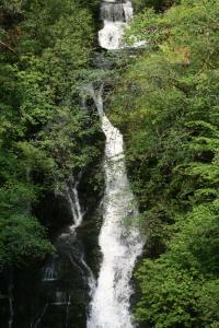 a waterfall in the middle of a river at Arrandale House in Pitlochry