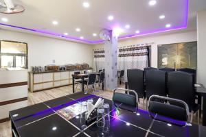a conference room with black chairs and a table at Hotel Aadesh Palace in Varanasi