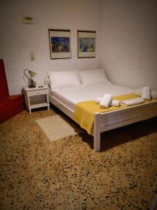 a bedroom with a large bed with a yellow blanket at Dialiskari #2 in Limniónas