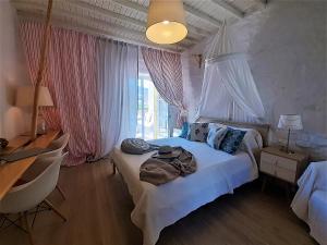 a bedroom with a bed with a hat on it at Sea Side Studios & Houses in Kalo Livadi