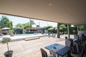 a patio with a pool and a table and chairs at Mikelina Boutique Hotel in Pallini