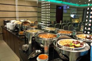 a buffet line with many different dishes of food at Oasis Deira Hotel in Dubai +32 photos