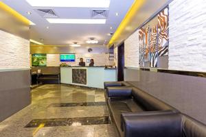 a lobby with a waiting room with a bar at Oasis Deira Hotel in Dubai
