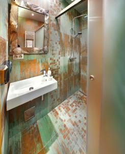 a bathroom with a sink and a shower at Noc na Chopku, Rotunda in Belá