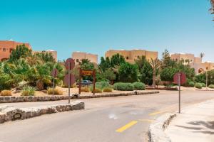 an empty street in front of a large building at El Gouna South Marina 1 Bedroom Apartement with private Jacuzzi in Hurghada