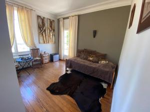 a bedroom with a dog laying on the floor at Manoir de la Marjolaine in Cabourg