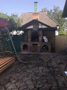 a patio with a brick oven in a yard at The Garden in Myrhorod