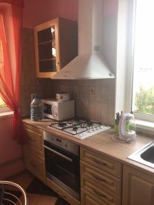 a kitchen with a stove top oven next to a window at The Garden in Myrhorod