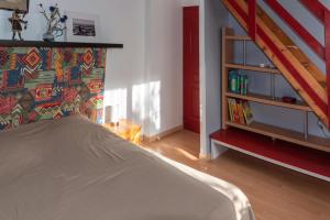 a bedroom with a bed and a book shelf at Gîte Les chênes in Fontenilles