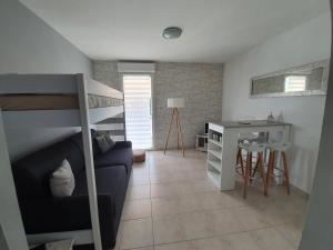 a living room with a bunk bed and a desk at studio presqu'île Fouras proche de la plage parking privé in Fouras