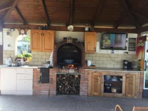 an outdoor kitchen with an oven and a stove at La foisor in Turda