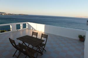 a table and chairs on a balcony overlooking the ocean at Splendide Apartments in Agios Nikolaos