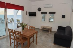 a living room with a table and a couch at Splendide Apartments in Agios Nikolaos