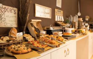 a bakery counter with various types of bread and pastries at Hotel Delle Fiere in Mozzate