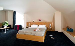 a bedroom with a bed with a tray of fruit on it at Hotel Delle Fiere in Mozzate +39 photos