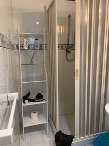 a white bathroom with a shower and a sink at B&B Casa Franca in Postiglione