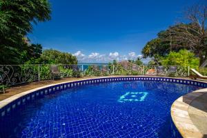 a swimming pool with a view of the ocean at Pousada Natureza in Morro de São Paulo