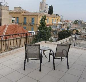 a patio with two chairs and a table on a balcony at Sky Hotel in Nicosia