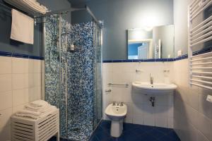 a bathroom with a sink and a toilet and a shower at Le Stanze del Cioccolato in Modica