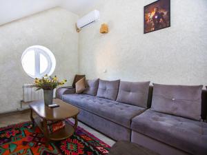 a living room with a couch and a table at Хостел Чердак in Makhachkala