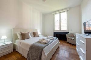 a white bedroom with a bed and a television at MILAN ROYAL SUITES LUXURY P.ZZA DELLA REPUBBLICA in Milan