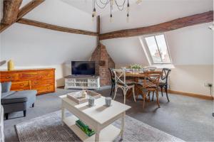 a living room with a table and a dining room at Guest Homes - The Merchant House Apartments in Hereford