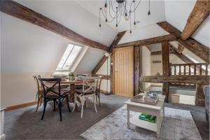 a dining room with a table and chairs at Guest Homes - The Merchant House Apartments in Hereford