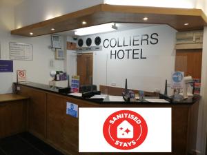 a lobby of a culliers hotel with a sign at Colliers Hotel in London