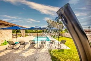 a water slide in front of a pool at Villa Aria Istria in Rovinj