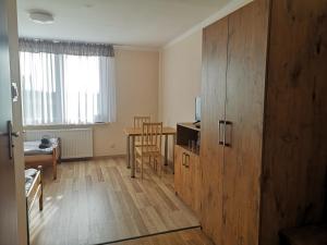 a living room with a wooden cabinet and a table at ORION in Ostrów Mazowiecka