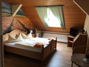 a bedroom with a bed with a painting on the wall at Hotel Schützenhaus in Brück
