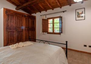 Postel nebo postele na pokoji v ubytování Agriturismo Il Poggio, Casa Rosa
