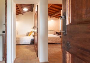 Postel nebo postele na pokoji v ubytování Agriturismo Il Poggio, Casa Rosa