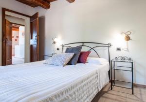 Postel nebo postele na pokoji v ubytování Agriturismo Il Poggio, Casa Rosa