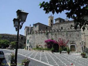 a large stone building with a street light in front of it at La Cantina di Giuliano in Falvaterra