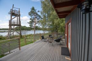 a deck with a table and chairs on a house at Villa Kultaa in Kotka