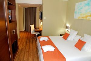 a hotel room with a bed with towels on it at Agua de Mar Hotel Boutique in Vigo +74 photos