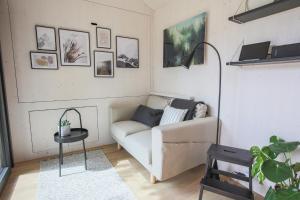 a living room with a couch and a table at Tiny House - Camping Wagenhausen in Wagenhausen