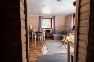 a living room with a table and a couch at Kultala Cottage in Korkeakoski